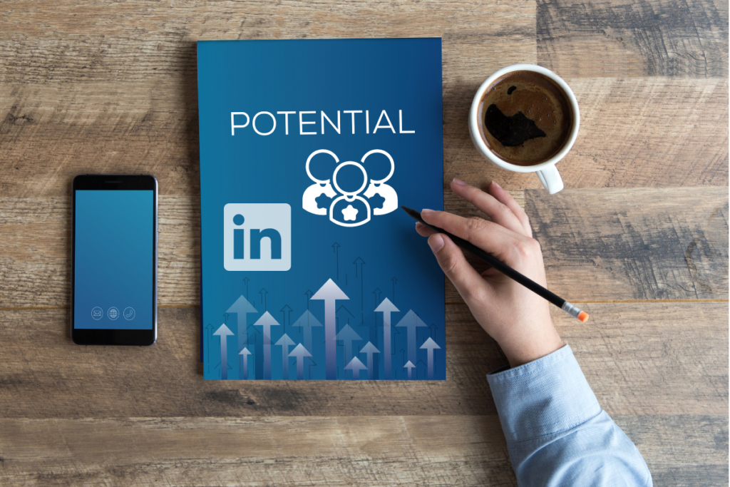 Person holding pencil next to a digital tablet displaying LinkedIn logo and the word "Potential," surrounded by upward arrows—symbolizing growth and automation setup for LinkedIn lead generation.